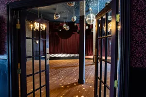 Open doors leading into Unicorn's ballroom with disco balls