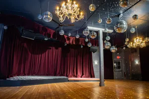 Unicorn's ballroom, showing the stage, velvet curtains, and disco balls